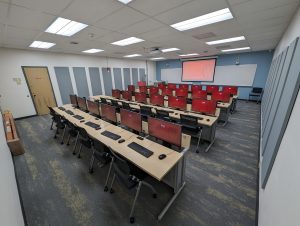 Computers setup on desks in room 250